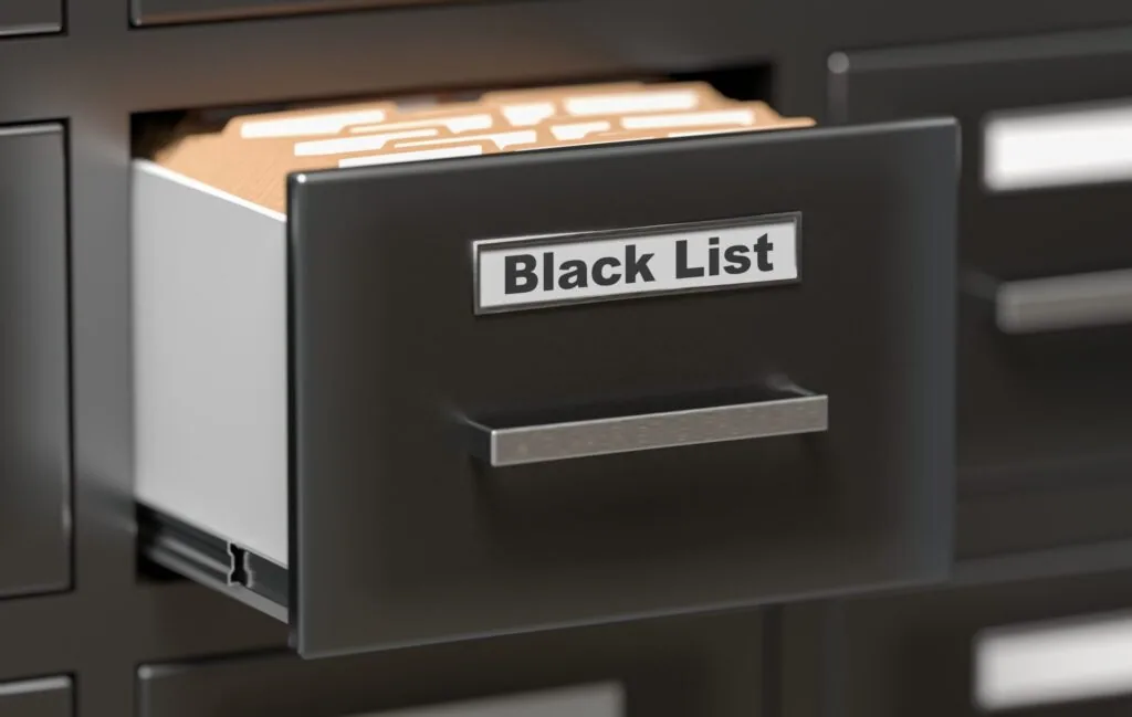 Black filing cabinet drawer labeled Black List with manila folders inside